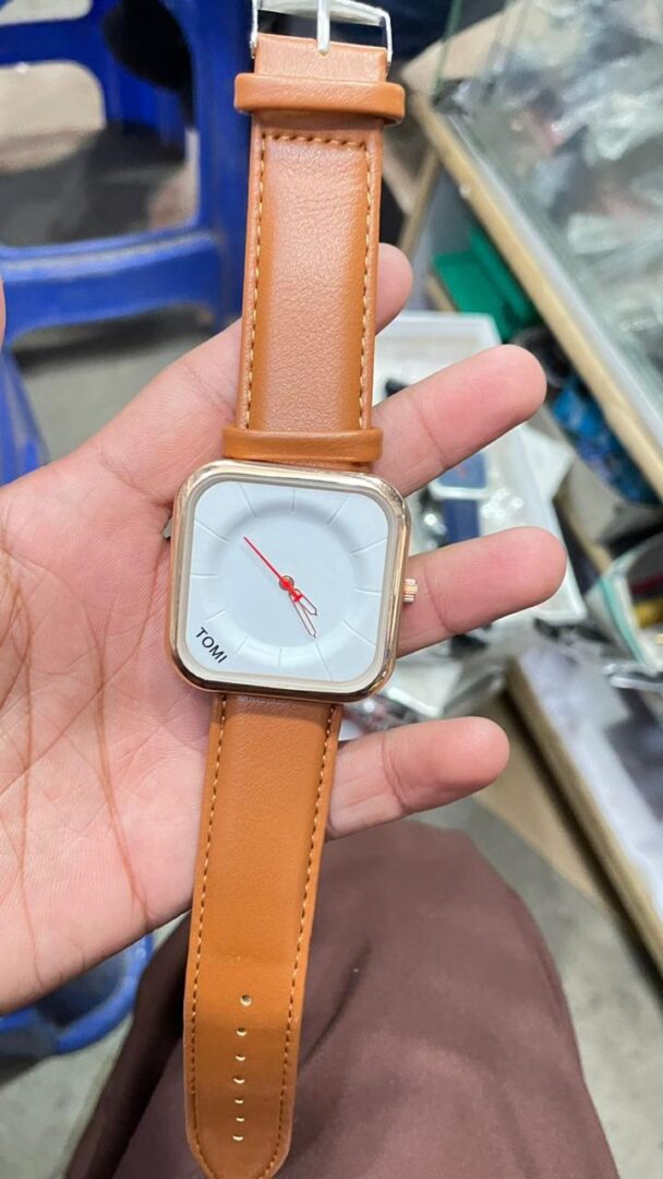 Tomi T-093 watch featuring a square dial and a brown leather strap.
