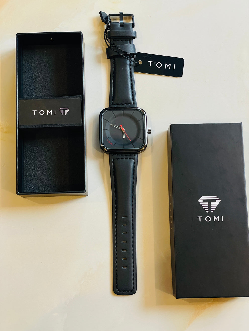 Tomi T-093 watch featuring a square dial and a black  leather strap.