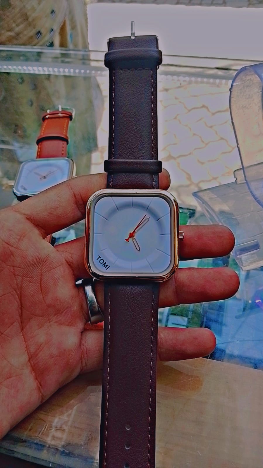 Tomi T-093 watch featuring a square dial and a brown leather strap.